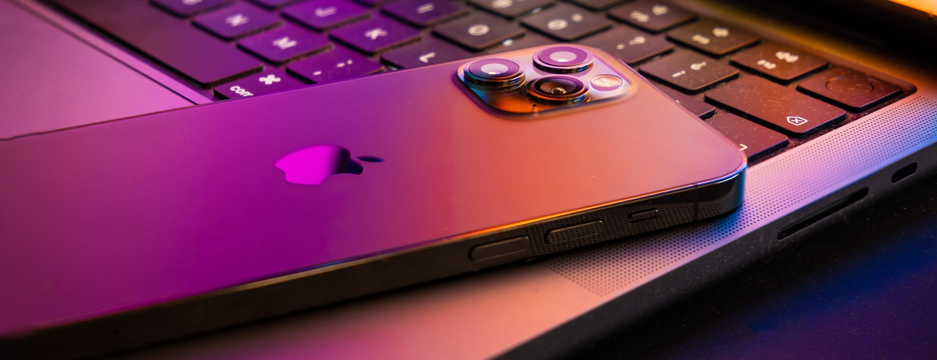 iPhone resting on the keyboard of a MacBook Pro, ready for servicing